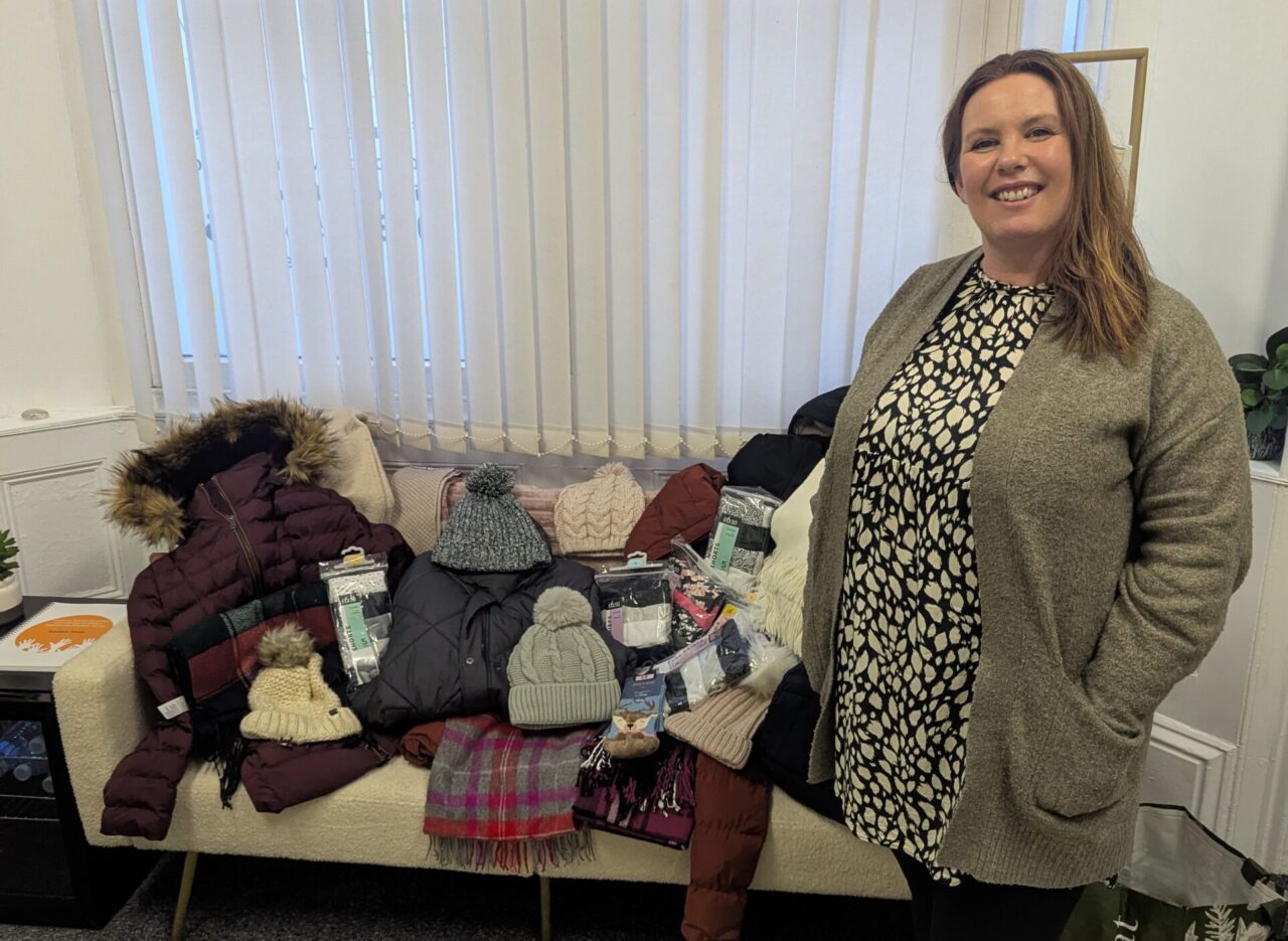 Linda from Gobaith Clothing with a clothing donation including hats, scarfs, coats and so much more.